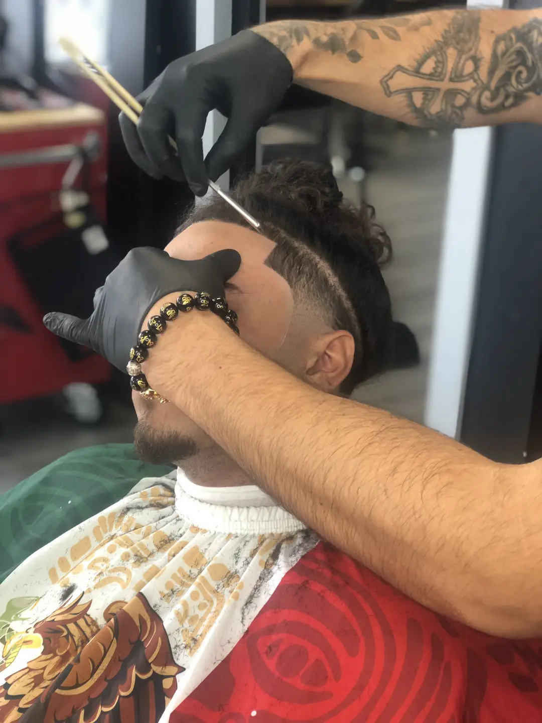 Barber giving a close fade haircut to a client.