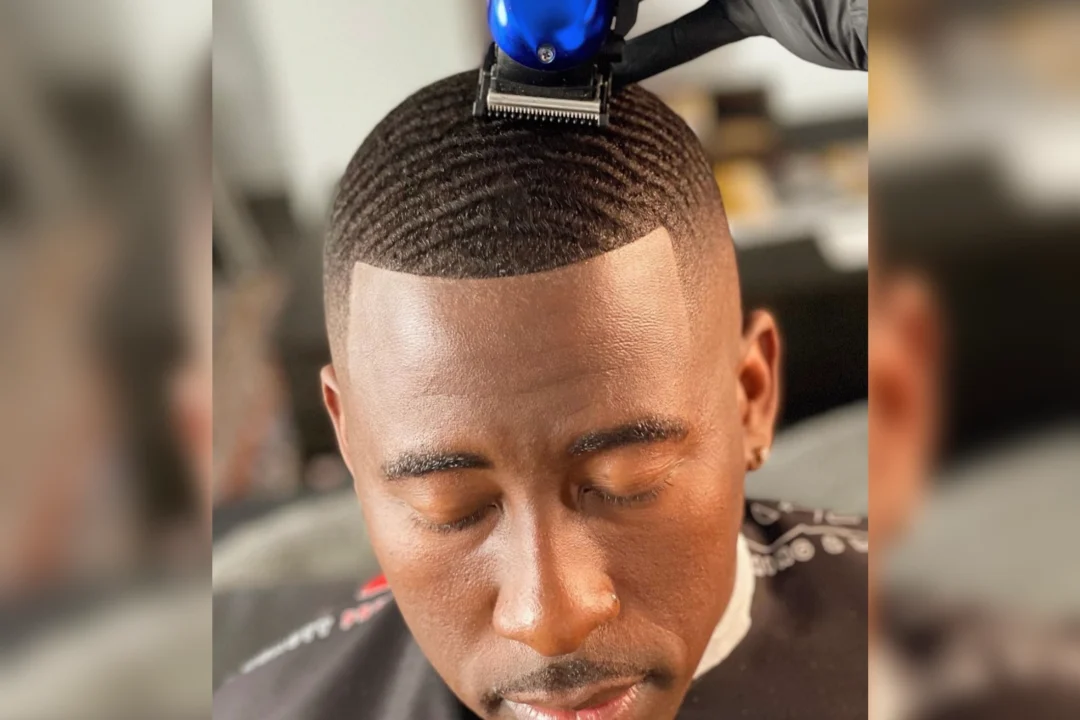 Man getting a precise haircut with a clipper.