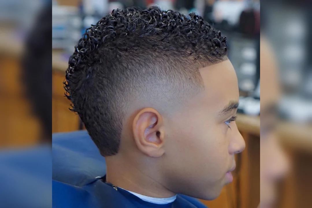 Boy with a fresh fade haircut in a barbershop.